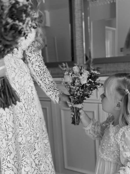 Sharing a touching moment between the bride and a young girl