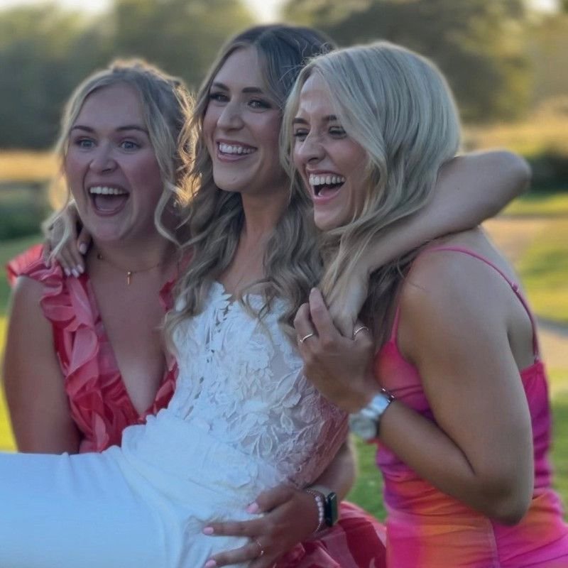 The bride with two of her bridesmaids, enjoying the moment