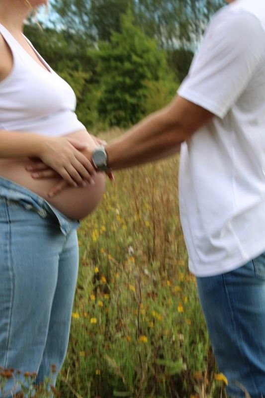 Soon to be mother and father enjoy the kicking of their child